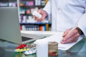 Pharmacist logging medications in a pharmacy 