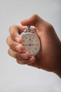 A hand holding a clock to show time limits for a pharmacy claim.
